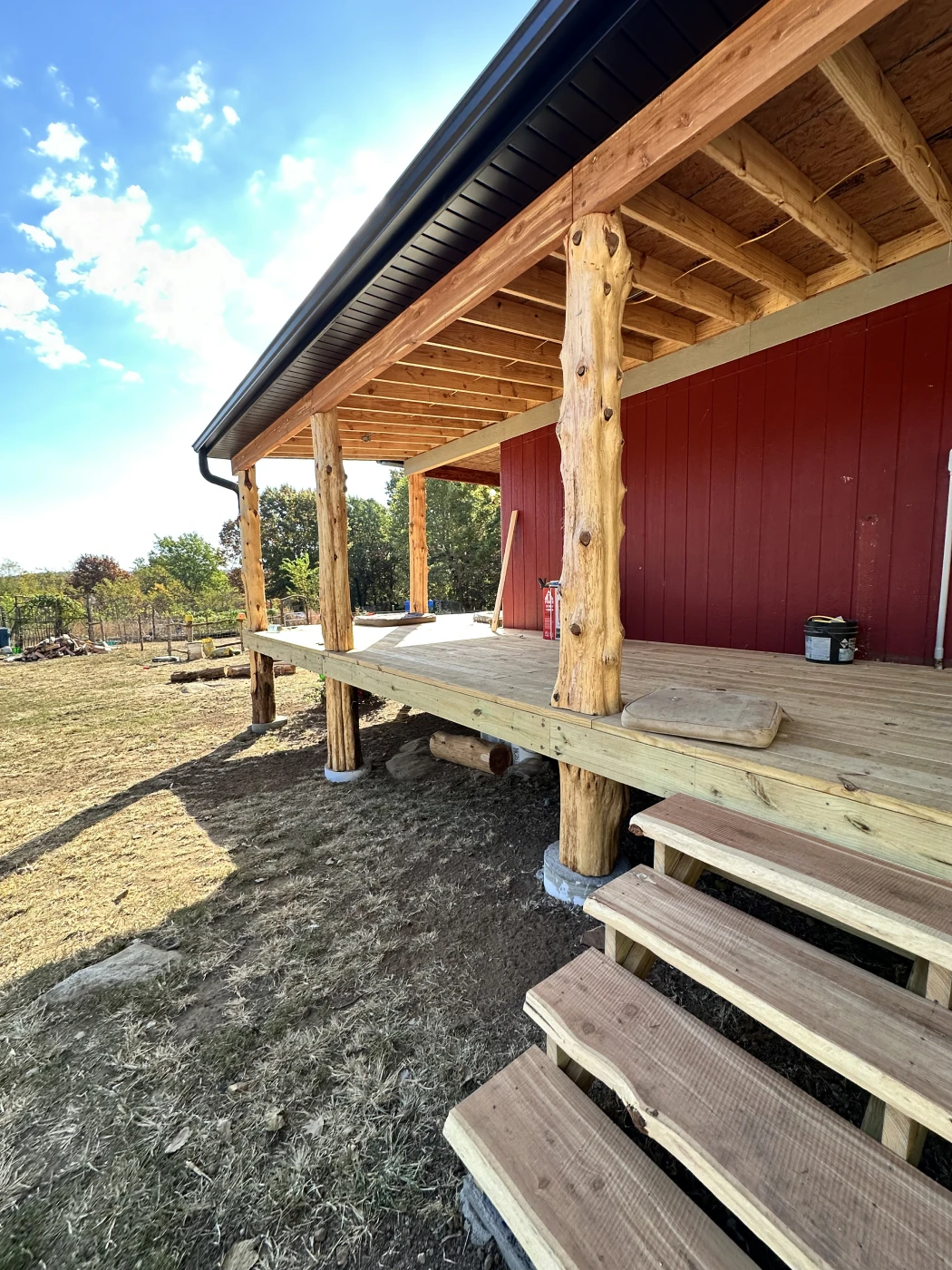 Red building with wooden deck