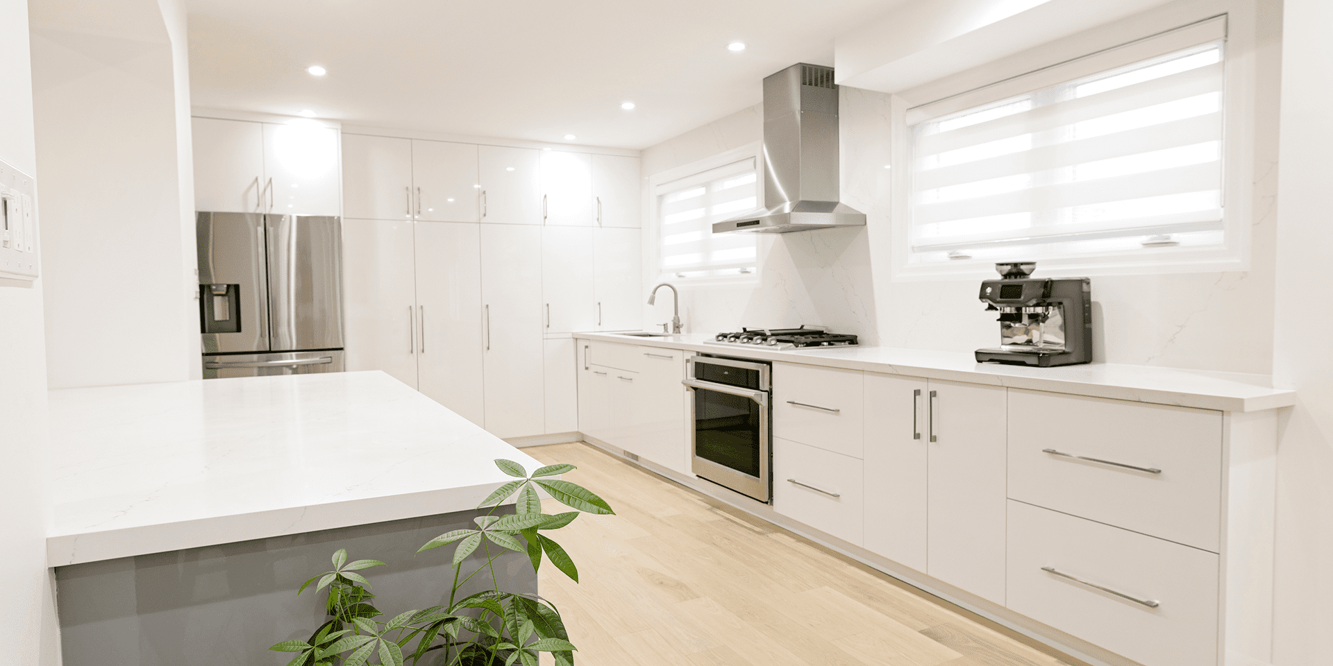 Modern white kitchen with stainless steel appliances